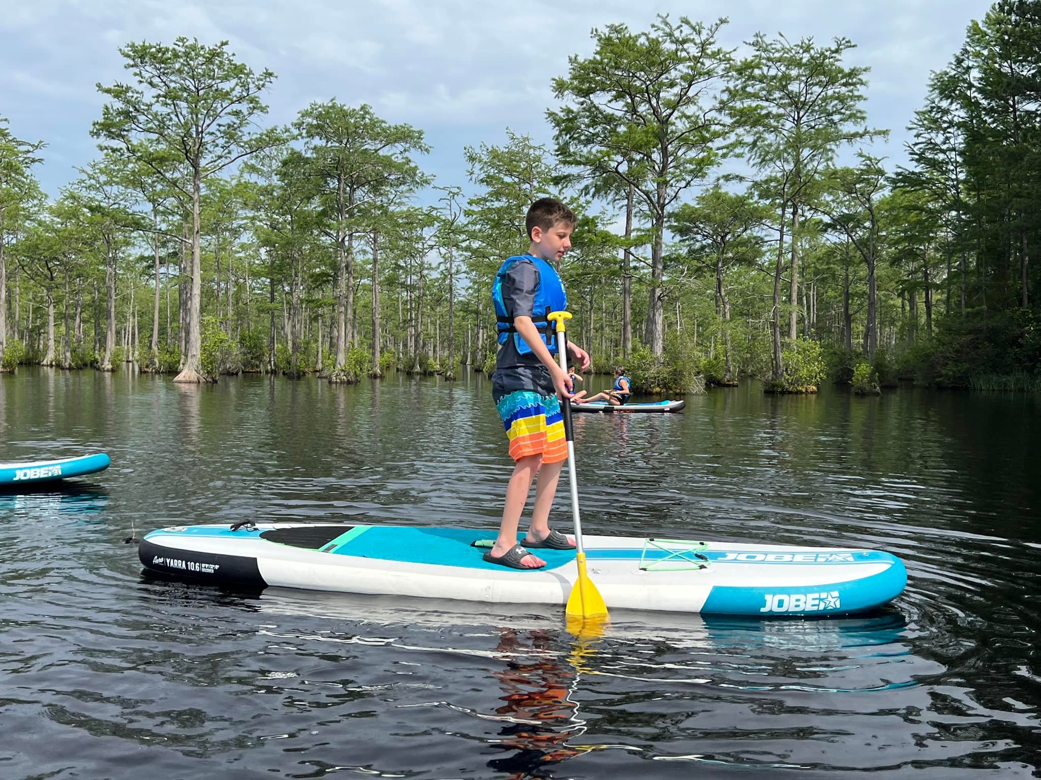 A man made lake with swimming area, aqua park, canoes, stand up paddleboards, and kayaks. Lake Safety: Every guest, at any swimming level, is required to wear a life jacket at all times. Note: beach towels are not provided.